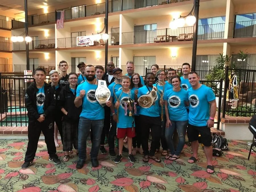 team of muay thai fighters with three champions